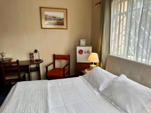 Una cama o camas en una habitación de El Balcon Hostal Turistico