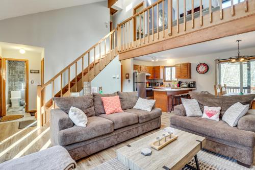 a living room with a couch and a table at Private Spa, Fire Pit and Deck Poconos Home! in Long Pond