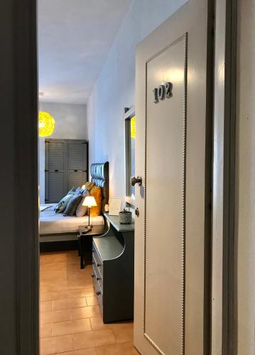 a bedroom with a bed and a desk and a door at Eleana Apartments in Hersonissos