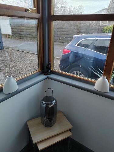 a window with a blender on a table next to a car at Westview in Buckie