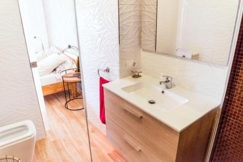 a bathroom with a sink and a mirror at Cozy apartment in Playa de la Américas, 60 m² with pool in Playa de las Americas
