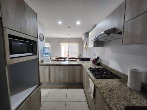 a kitchen with a stove and a counter top at Mazatlan vacation home in Mazatlán