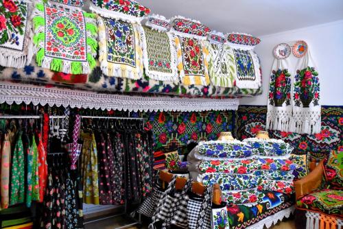 a store filled with lots of different colored fabrics at Pensiunea Inima Maramureșului in Breb