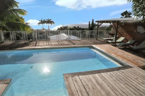 La alberca dentro o cerca de Maison spacieuse à Pointe-Noire avec piscine partagée 110 m²