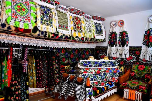 a room filled with lots of different colored fabrics at Pensiunea Inima Maramureșului in Breb