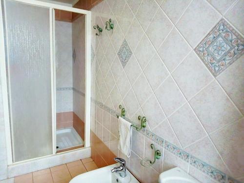 a bathroom with a toilet and a shower and a sink at Villa Gabry in Floridia