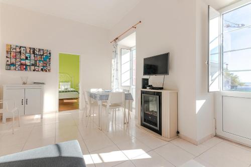 a living room with a fireplace and a dining room at Alfama Santa Apolonia Apartment in Lisbon