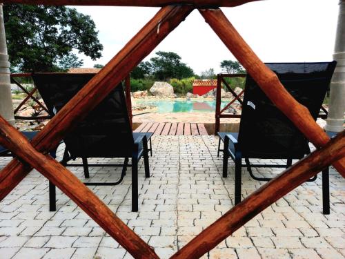 a view of a patio with two chairs and a pool at Hotel Aldea Katún in Izamal