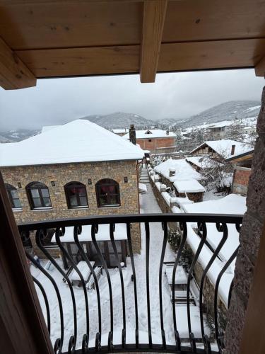 a view from a balcony with snow covered roofs at Hotel Ambassador Voskopojë in Voskopojë