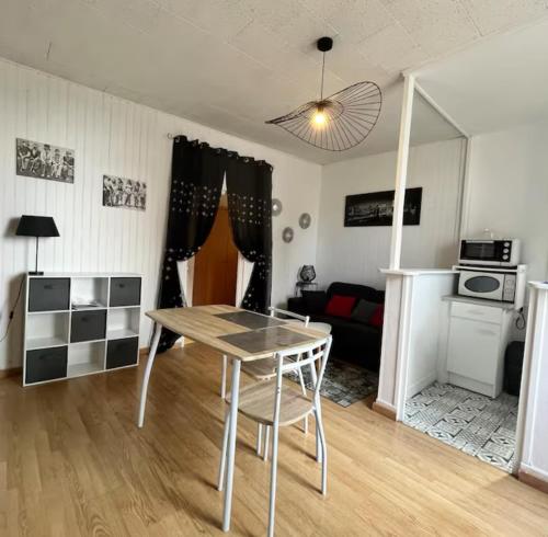 un salon avec une table et un canapé dans l'établissement Les terrasses de Massenet 1, à Néris-les-Bains