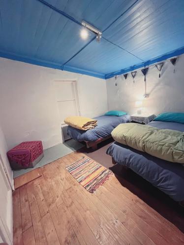 a room with two beds in a tent at SURFHOUSE Pichilemu in Pichilemu