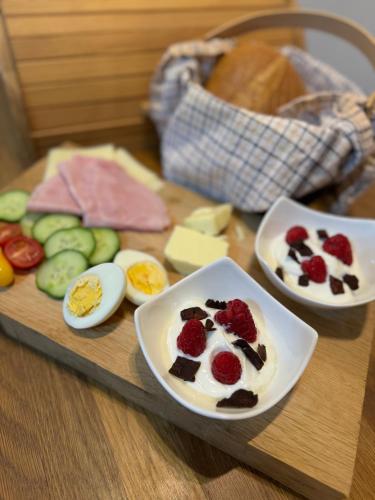 a tray of food with eggs and fruit on a table at Dančí zátiší in Nový Oldřichov