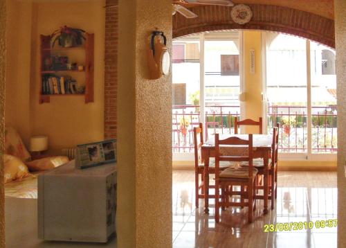a kitchen and dining room with a table and chairs at Welcoming apartment in Mazarrón 56 m² with shared poolmo in Mazarrón