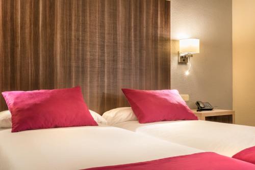 a bedroom with two red pillows on a bed at Ona Diana Park in Estepona