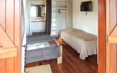 a small room with a bed and a window at Bungalow charmant à Saint-François avec jardinB in Saint-François