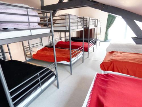 a group of bunk beds in a room at Retraite Champêtre Spacieuse près de Nouart avec Jacuzzi in Nouart