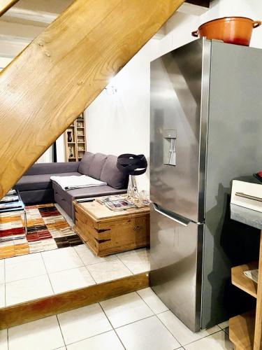 - un salon avec un canapé et un réfrigérateur dans l'établissement Villa spacieuse à Prailles-La Couarde avec piscine privée 100 m² !, à La Couarde