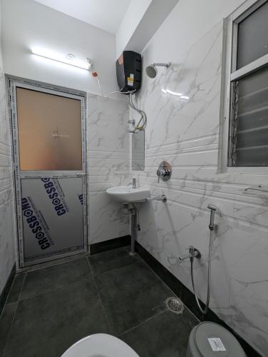 a bathroom with a toilet and a sink at Ridge View Homestay in Bāghdogra