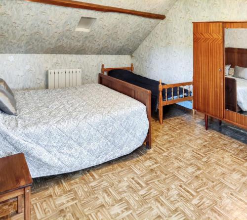 a bedroom with a bed and a dresser and a bed sidx sidx sidx sidx at Chaleureuse Maison de Campagne avec Terrasse et Cheminée in Lignières-de-Touraine