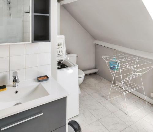 a bathroom with a sink and a toilet at Chaleureuse Maison de Campagne avec Terrasse et Cheminée in Lignières-de-Touraine