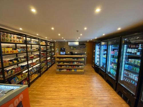 a grocery store aisle with lots of food and drinks at Flat S4 Hotel - Águas Claras - Brasília in Brasilia