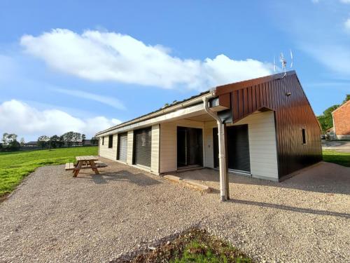 a building with a picnic table in front of it at Maison spacieuse à Cerniébaud avec magnifique jardin. in Cerniébaud