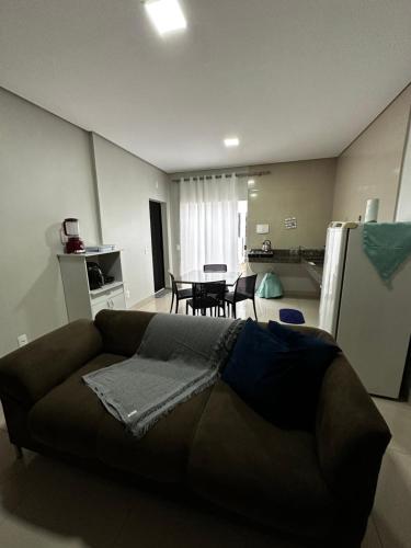 a living room with a couch and a kitchen at Casa 05 próximo ao centro Delior 2 in Palmas