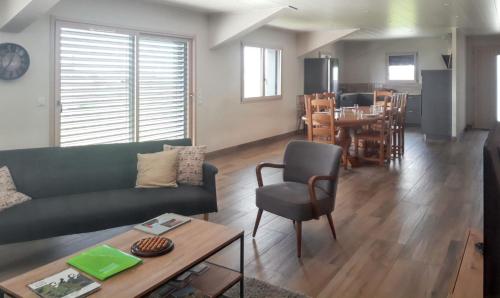 a living room with a couch and a table at Maison spacieuse à Cerniébaud avec magnifique jardin. in Cerniébaud