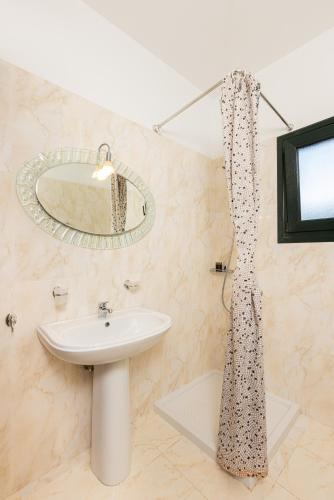 a bathroom with a sink and a shower curtain at Villa Platanaki in Kerveli