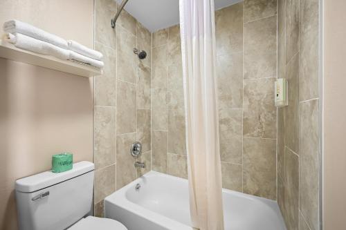 a bathroom with a toilet and a shower at Quality Inn Fort Myers Cape Coral in Fort Myers