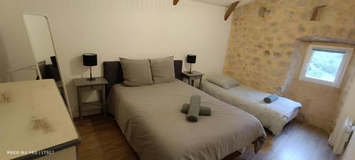 a bedroom with a bed with a cross on it at Le Temps Suspendu in Saint-Pierreville