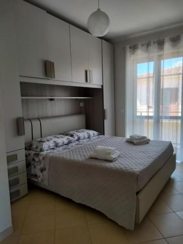 a bedroom with a bed with two towels on it at DENIA'S HOME in SantʼEufemia Lamezia
