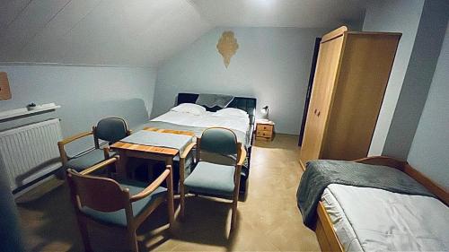 a hospital room with a bed and a table and chairs at Dom Na Widoku w górach Szczyrk in Szczyrk