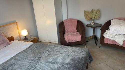 a bedroom with two beds and a chair and a table at Dom Na Widoku w górach Szczyrk in Szczyrk