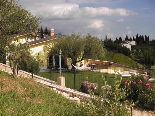a house on a hill with a fence at B&B Al Cristo in SantʼAmbrogio di Valpolicella