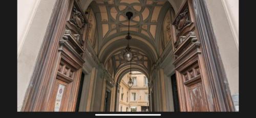 a hallway in a building with a ceiling and windows at FALERON Santa Lucia in Naples