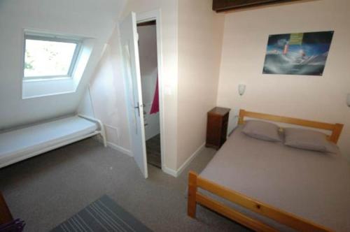 a bedroom with a bed and a window and a door at La Grange du Devezou in Saint-Jacques-des-Blats