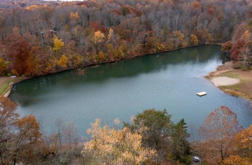 an aerial view of a lake with a boat in it at Edgewater Escape, Hocking Hills, Hot Tub, Pond in Rockbridge