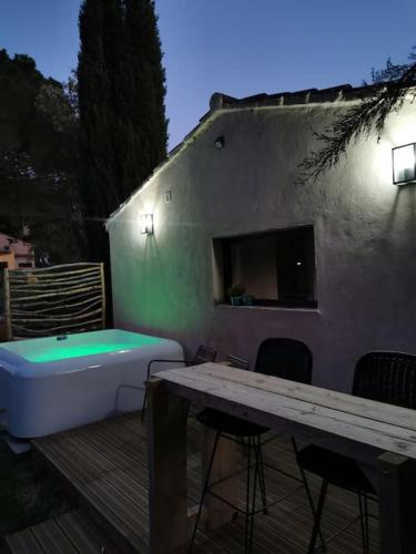 a bath tub sitting on a deck next to a building at L'Atelier de Maison VB in Le Beausset