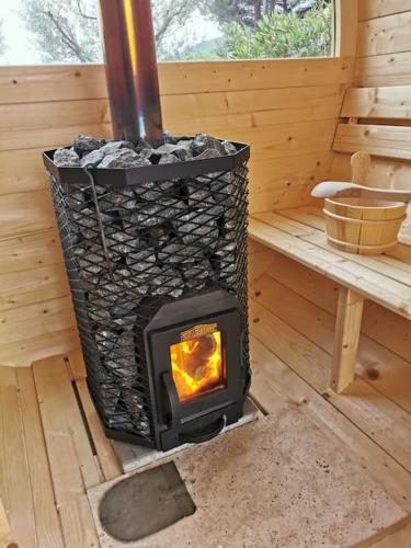 a wood stove in a cabin with a bench at L'Atelier de Maison VB in Le Beausset