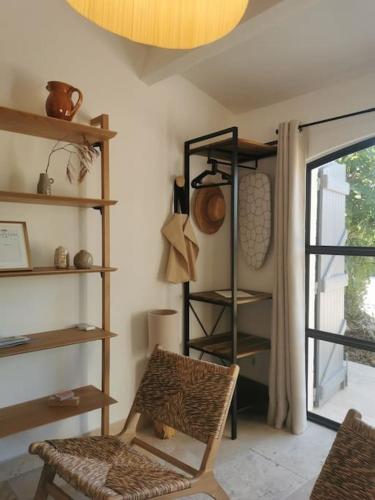 a room with a chair and shelves and a window at L'Atelier de Maison VB in Le Beausset