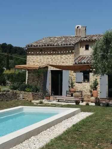 a house with a swimming pool in front of a house at L'Atelier de Maison VB in Le Beausset