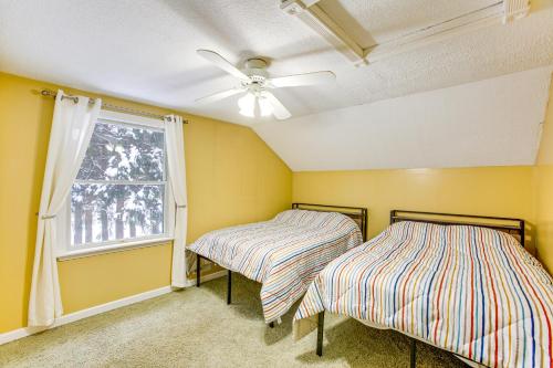 two beds in a room with a window at Less Than 1 Mi to ATV Trails Cadillac Golf Retreat! in Cadillac