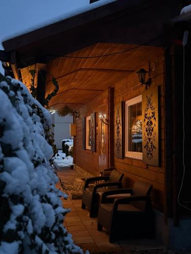 a row of benches on a porch in the snow at U Małgorzaty in Wojtkowa