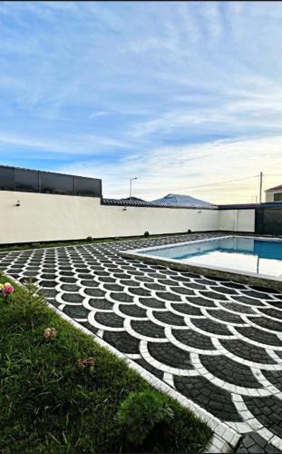 a building with a swimming pool next to a building at Gabala Double Villas in Gabala