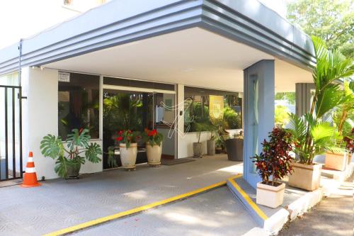 Un edificio con plantas en macetas en frente de él. en Di Roma Rio Quente TURISMO, en Rio Quente