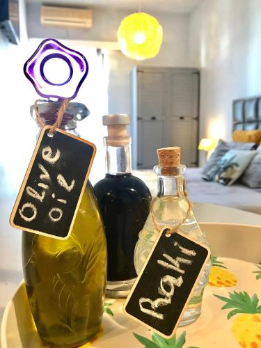 two bottles of oil on a table with signs on them at Eleana Apartments in Hersonissos
