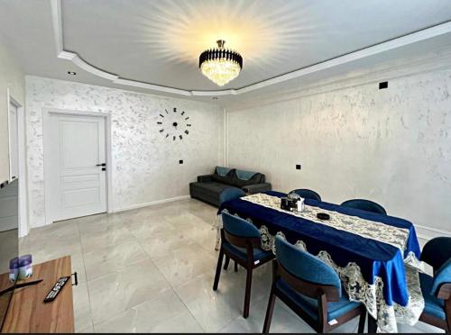 a living room with a table and a couch at Gabala Double Villas in Gabala