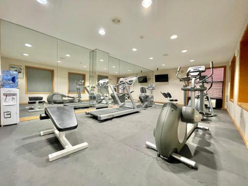 a gym with several treadmills and exercise bikes at FairBridge Inn & Suites Fort Wayne in Fort Wayne
