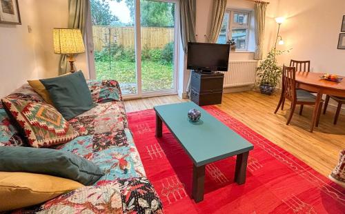 a living room with a couch and a table at THE ASH TREE - Charming & comfortable apartment in Frome